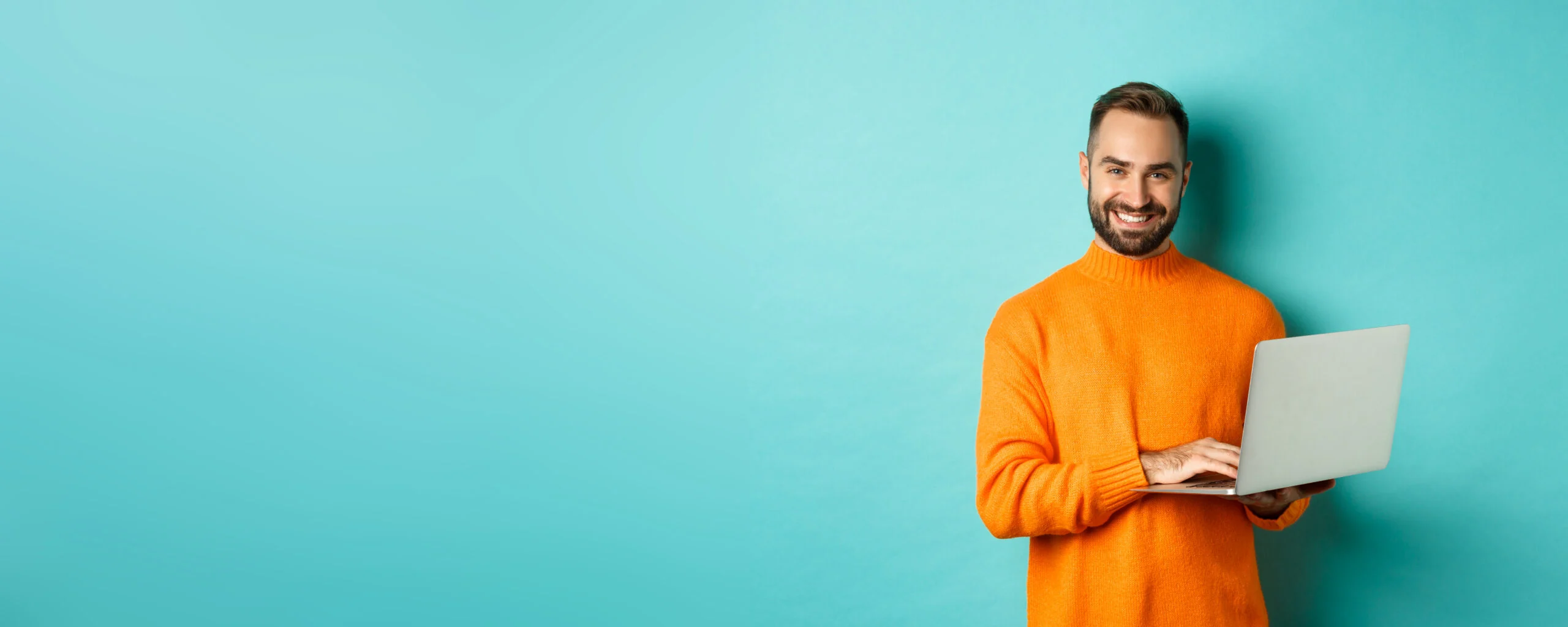 handsome adult man freelancer working with laptop smiling camera typing computer keyboard stan scaled